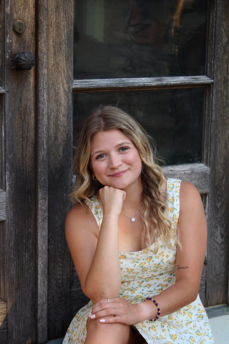 Portrait beside a weathered wooden door