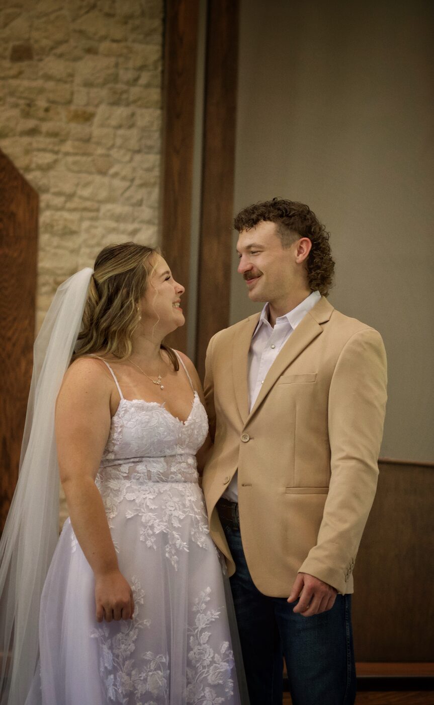 Bride and groom face to face, laughing