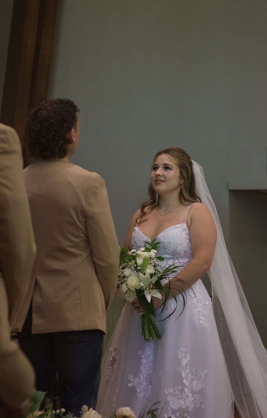 Bride and groom close, holding bouquet